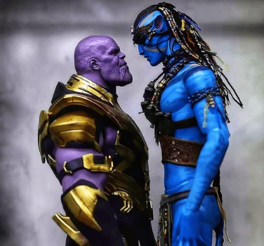 A face-off between two fictional characters: Thanos, a purple figure wearing gold armor, and a blue humanoid figure resembling a Na'vi from Avatar. They are standing close together in a confrontational pose.